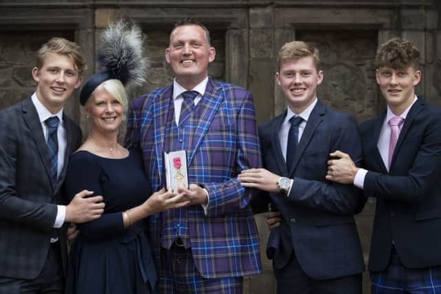 Doddie Weir with wife Kathy and their three sons, from left, Hamish, Ben and Angus after receiving his OBE from Queen Elizabeth II during an Investiture ceremony at the Palace of Holyroodhouse in Edinburgh. (Photo by Jane Barlow - WPA Pool/Getty Images)