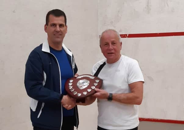 Gala SRC captain Del Sharratt presents champion Sir Andrew Dowlen-Gilland with the Alex Doherty Memorial Shield.