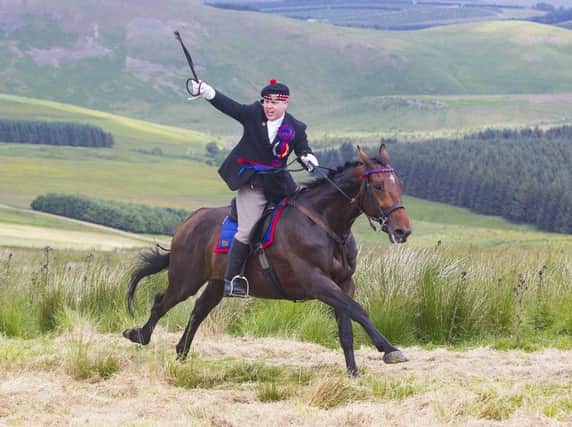 Callant Euan Munro gives the battle cry Jethart's Here as he gallops up Carter Bar.