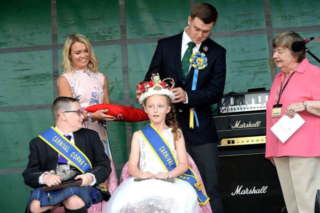 Crowning the Burnfoot Carnival queen, Leah Bell, is Hawick Cornet Conner Brunton, with Victoria Campbell and Ann Knight looking on.