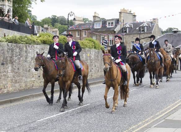The cavalcade leads town on Saturday morning.