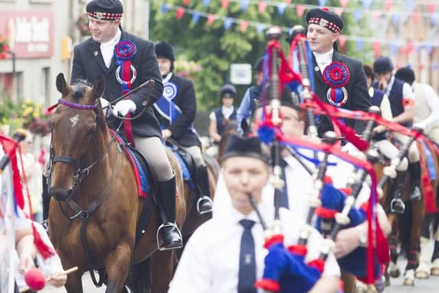 The Jedburgh RBLS Pipe Band leads the cavalcade out of town on Saturday morning.