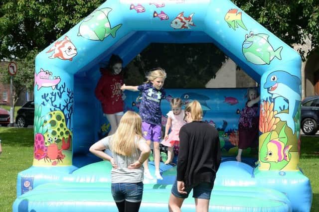 Children enjoyed the bouncy castle on the Green.