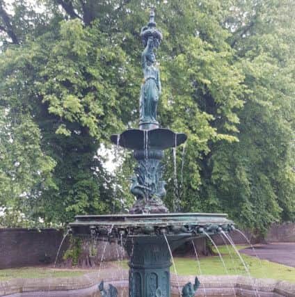 The fountain in the grounds of Selkirk's Victoria Halls, with water pouring from the left of the large middle bowl.