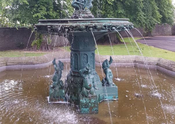 The fountain in the grounds of Selkirk's Victoria Halls, with water pouring from the left of the large middle bowl.