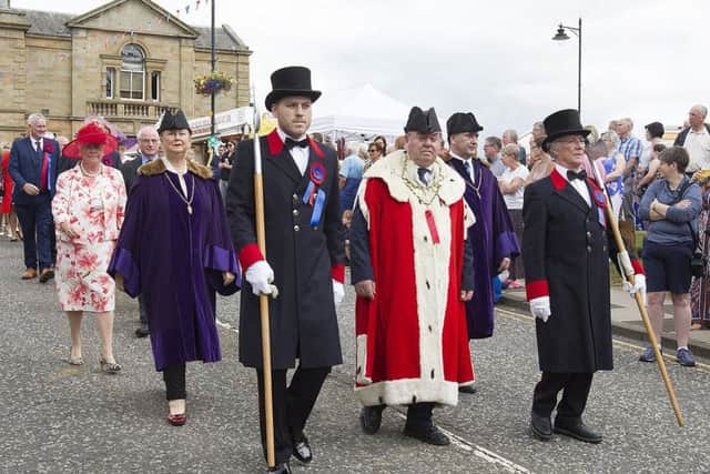 Provost Harvey Oliver heads to the war memorial flanked by his halberdiers.