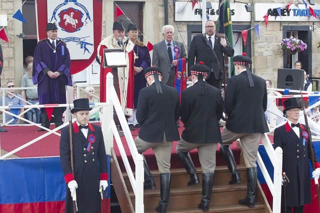 Callant Euan Munro and his henchmen receive their sashes and the Jethart flag and axes during the investiture ceremony.