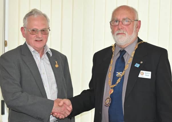 Retiring Jedburgh Rotary Club president Eddie Muir, left, hands over the reins to his successor, Martin Breach.