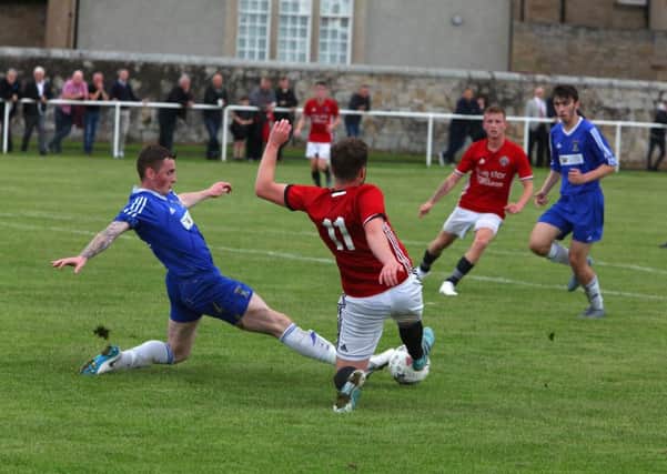 Coldstream's Lewis Knox (in blue) and Marc Berry of Gala FR contest the ball.