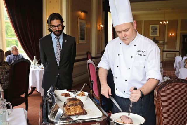 Cringletie head chef Iain Gourlay carves, as maitre dâ Leonardo Sandri looks on.