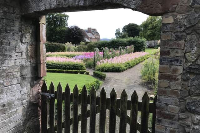 Cringletie House, viewed through its walled garden, where the hotel owners hope to grow all its own fruit and veg.