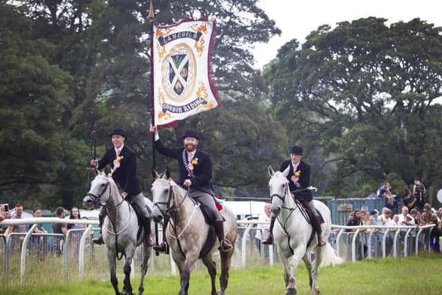 Langholm Cornet Henry Jeffrey with his right and left-hand men Iain Little and Stuart Murray.