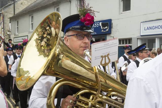 The town band decorates their hats for the occasion.