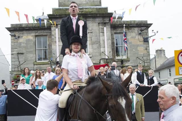 Rae Elliot cries the Langholm fair in the town square.