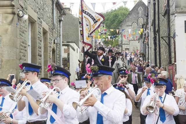 The town band leads the procession.