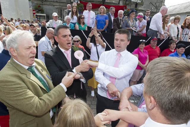 Auld Lang Syne is sung in the square.