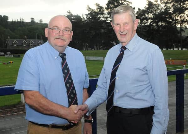 Outgoing president Bennie Rafferty welcomes successor Gus Boag, right.