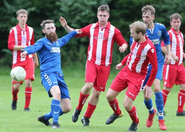 Tweedmouth Rangers (in stripes) in action against Earlston Rhymers (picture by Brian Sutherland).