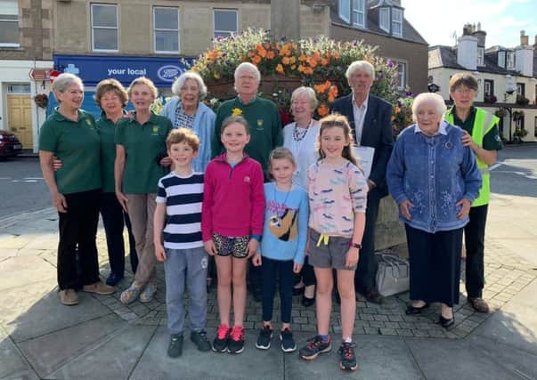 Melrose was looking its blooming best last Thursday when two Keep Scotland Beautiful judges cast their eyes over the latest horticultural efforts of a band of dedicated volunteers.
Terry Stott and Sandra MacLennan were met by two of the oldest and several of the youngest Melrose In Bloom members at the beginning of their judging visit at the Market Cross.