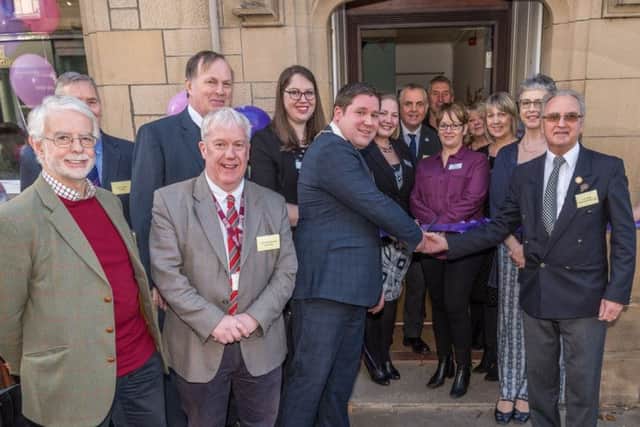 Grand opening...the new Alzheimer Scotland resource centre opened in Kelso town centre on January 18 with Provost Dean Weatherston and Jim Sykes cutting the ribbon.