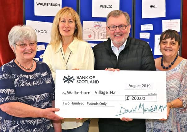 Tweeddale MP David Mundell presents a £200 cheque to Walkerburn Village Hall representatives, left to right: Win Pennel, secretary; Kinta Lindsay, committee member and Denise Hanks, vice-chairwoman