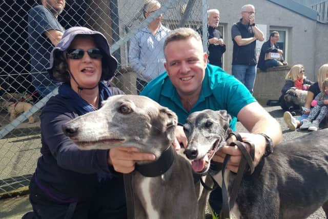 Kitty Harrison and Jamie Thompson with Misty and Rosie, who are retired greyhounds.