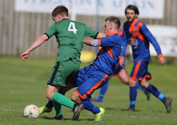 Liam Lavery, in blue, goes in for a challenge against Stirling University. The Hawick man was later one of two home players to see red (picture by Brian Sutherland).