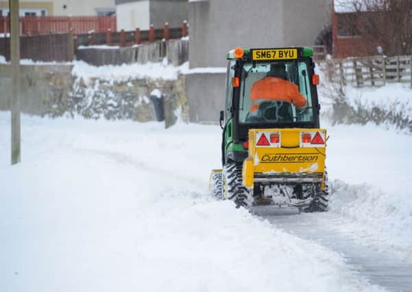 Council gritter clears the paths in Peebles. Scottish Borders Council chiefs want to cut early-morning clearances, a move some councillors are against.