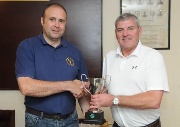 Chairman of Selkirk EXSBs, Gary Guthrie, hands over the Shawburn Cup to Selkirk MC Officer David Heard (picture by Grant Kinghorn)