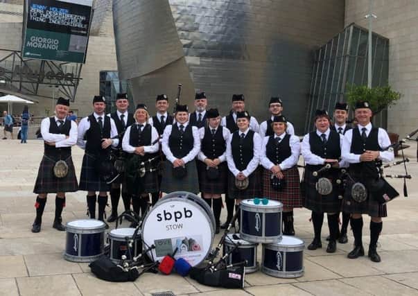 Scottish Borders Pipe Band performs at the Guggenheim museum in Bilbao as part of the Getxo International Folk Festival.
