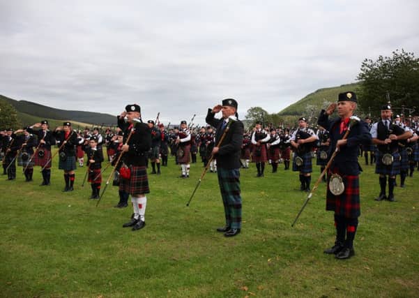 The massed bands and drum majors give a salute to chieftain Stuart Robinson.