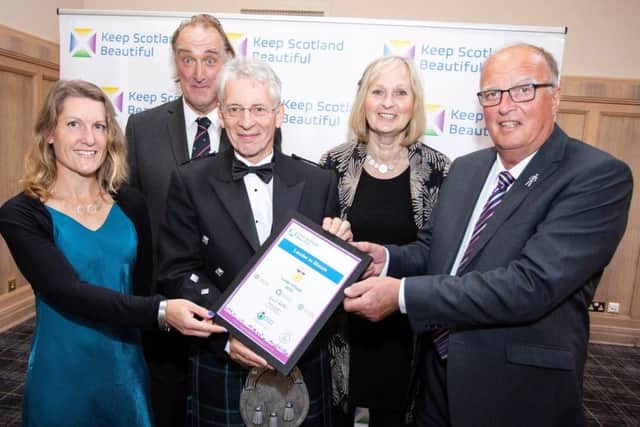 Lauder In Bloom members Trudi Jack, Hugh McKinven, Alistair Smith and Ray Theedam-Parry collect a gold award for best large village from Lindsay Montgomery at the Keep Scotland Beautiful awards.