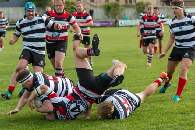 Tough tackling between Kelso, in black and white stripes, and Stirling Wolves (picture by Gavin Horsburgh)