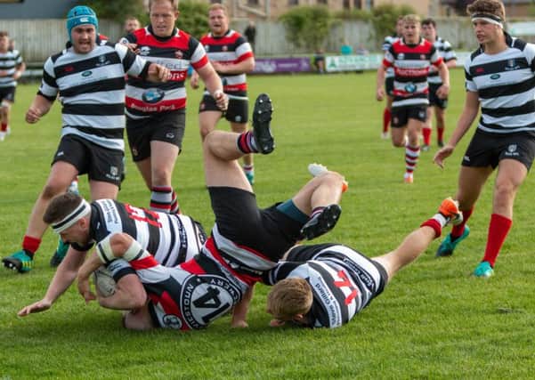 Tough tackling between Kelso, in black and white stripes, and Stirling Wolves (picture by Gavin Horsburgh)
