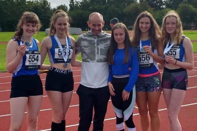A silver medal for TLJT girls U17s in the 4 x 300m relay at Pitreavie. From left, Annabel Murray, Brogan Bettie, Gavin Taitt (coach), Georgia Wood (reserve) Danielle Lockie and Emma Brus.