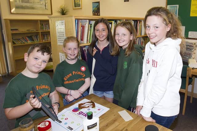 Stow Primary school pupils, Archie Brown (9) and Isabelle Mack (8) demonstrate the giki app, used to live more sustainably to Emily Lewington, Sophie Edwardson and Megan Brown.