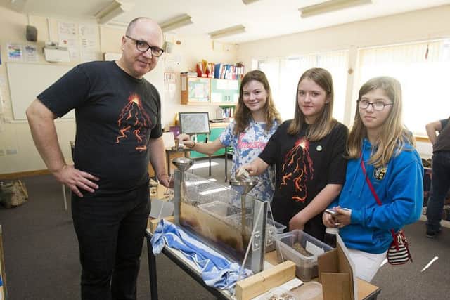 Dan Banford exploring sedimentary rock with Ailsa Simmons, Genevieve Entrikan and Iona Stormont.