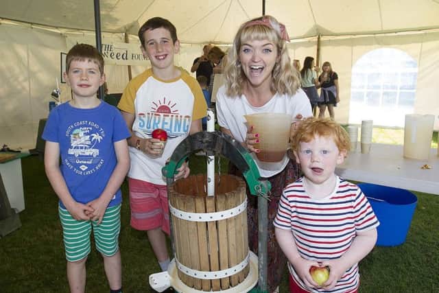 Fergus Rawson, Isaac Stuart and Hamish McLeman press apples with Charlotte Watson from Greener Melrose.