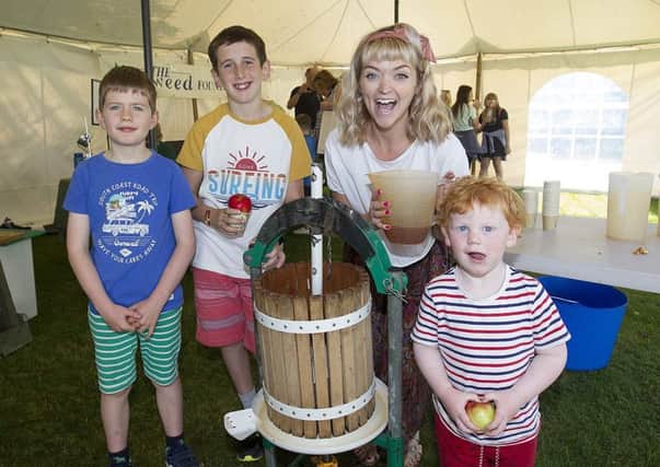 Fergus Rawson, Isaac Stuart and Hamish McLeman press apples with Charlotte Watson from Greener Melrose.