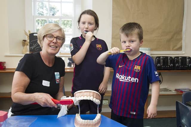 Helen Brand from the NHS Smile team with Hanna and Callum Ramsay.