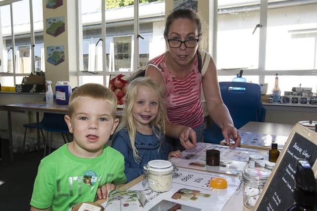 Jacob Kowbel makes soap with Orla and Maggie Largy.