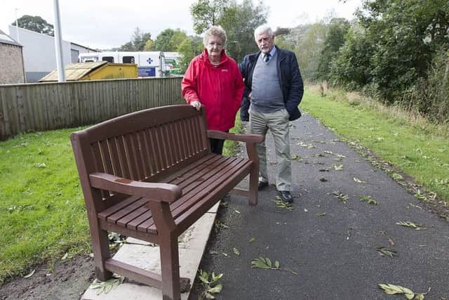 Local resident Mary Ferguson dismayed over vandalism of benches in Jedburgh with councillor Jim Brown.