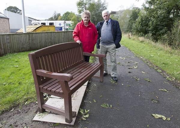 Local resident Mary Ferguson dismayed over vandalism of benches in Jedburgh with councillor Jim Brown.