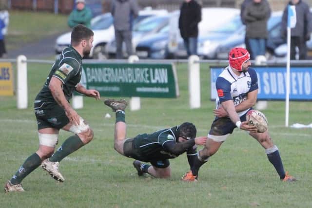 Luca Berti of Selkirk feeds out after eluding a Hawick tackle, although the Greens won 15-22 (picture by Grant Kinghorn)